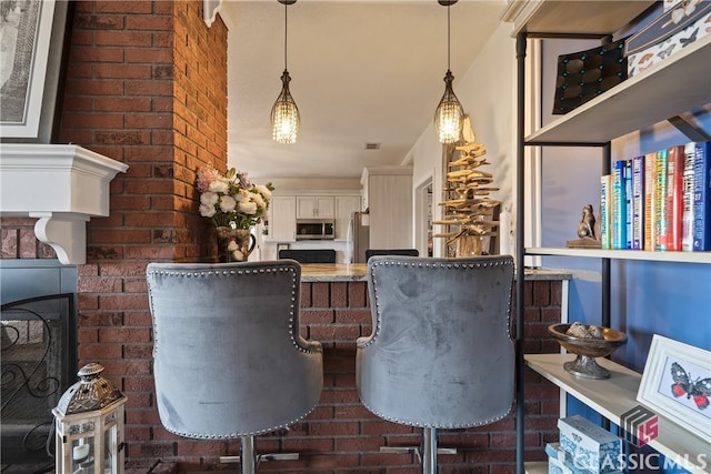 interior space with brick wall and a fireplace