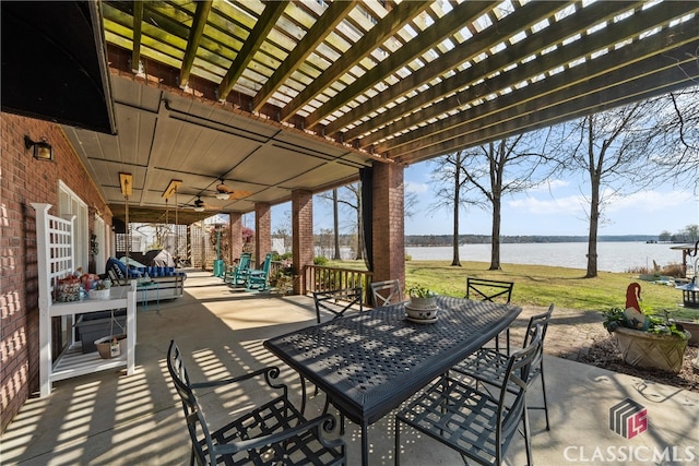 view of patio / terrace featuring a water view and a pergola