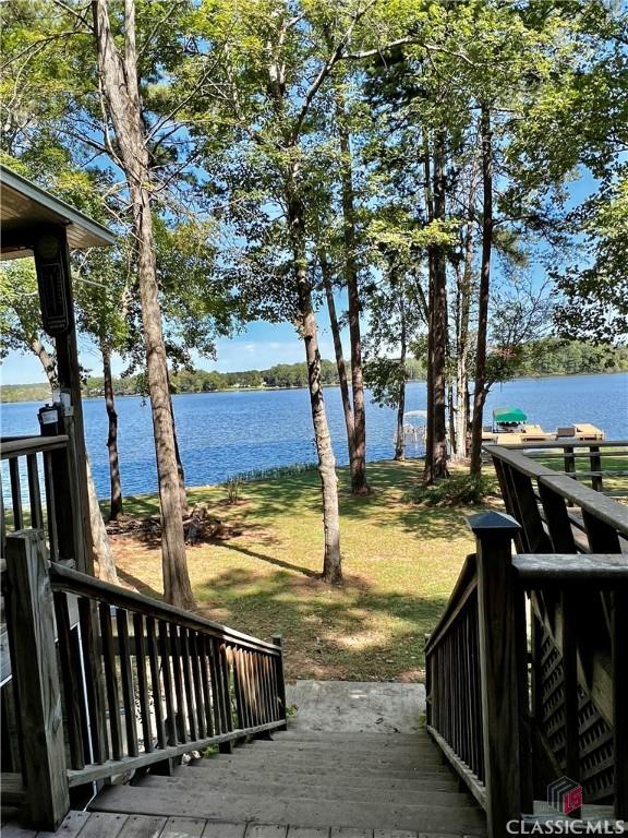 384 Arrowhead Trl Unit 4, Eatonton, GA 31024 - wooden deck featuring a yard and a water view