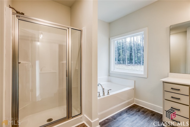 bathroom with vanity, hardwood / wood-style floors, and independent shower and bath