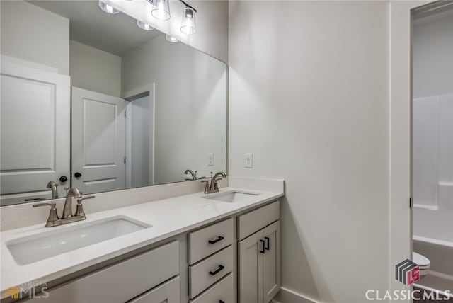 bathroom with vanity and a washtub