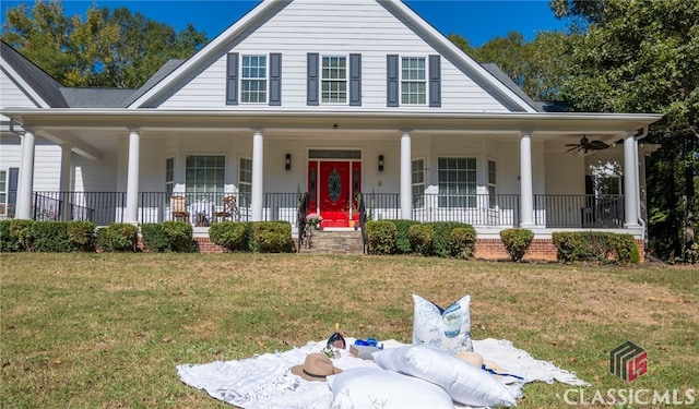 farmhouse-style home featuring a front yard, covered porch, and ceiling fan