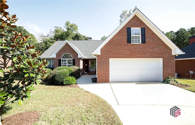 view of front of house featuring a garage and a front lawn