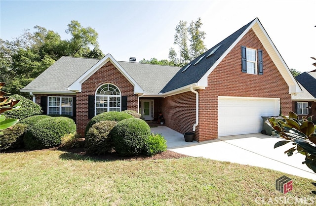 view of front of house with a front yard and a garage