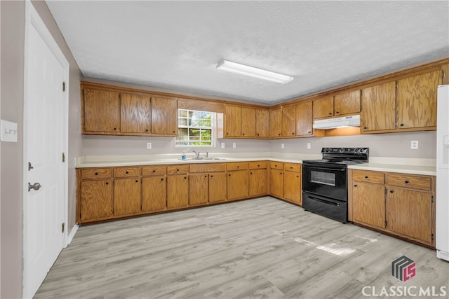 kitchen with white fridge, sink, light wood-type flooring, a textured ceiling, and black / electric stove