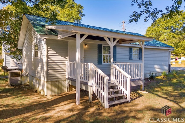 bungalow-style house with central AC and a front lawn