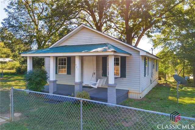 bungalow-style home featuring a porch and a front lawn