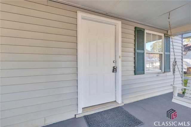 doorway to property featuring a porch