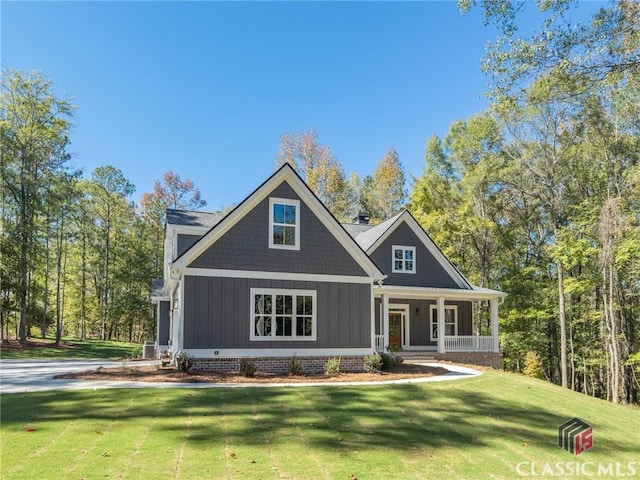 craftsman inspired home with covered porch and a front yard