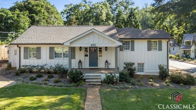 view of front of house featuring covered porch and a front lawn