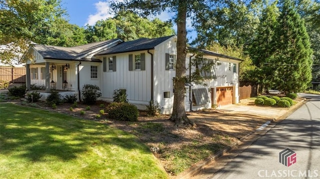 view of property exterior featuring a lawn and a garage