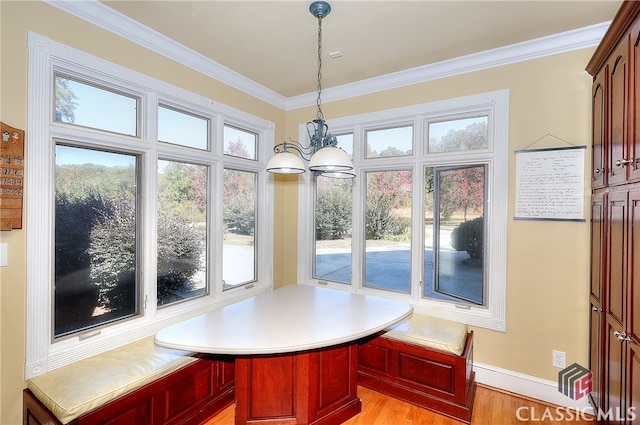 sunroom / solarium featuring a chandelier