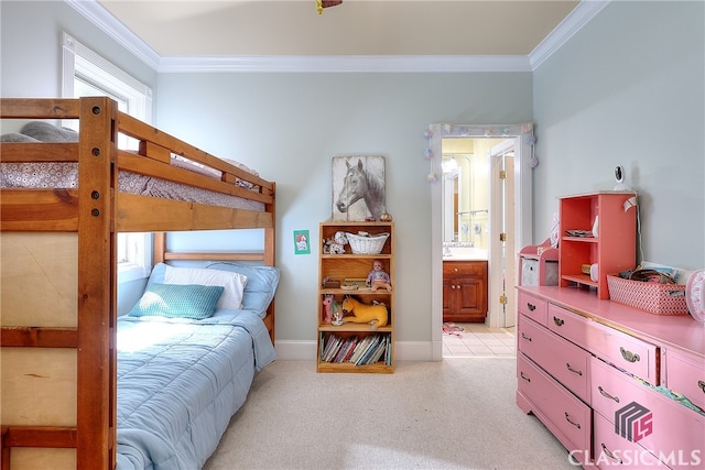 bedroom featuring crown molding, light carpet, and ensuite bath