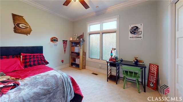 carpeted bedroom featuring ceiling fan and crown molding