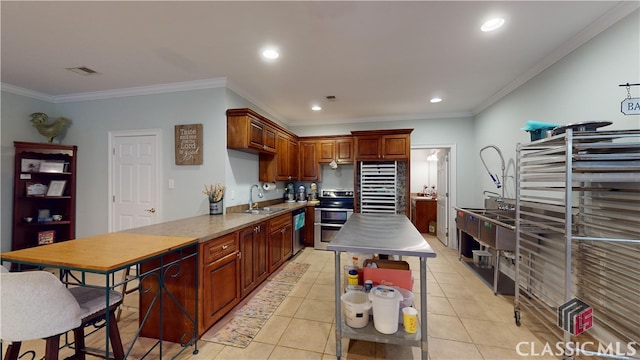 kitchen featuring sink, crown molding, appliances with stainless steel finishes, and light tile patterned floors