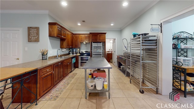 kitchen featuring crown molding, stainless steel appliances, sink, and light tile patterned floors