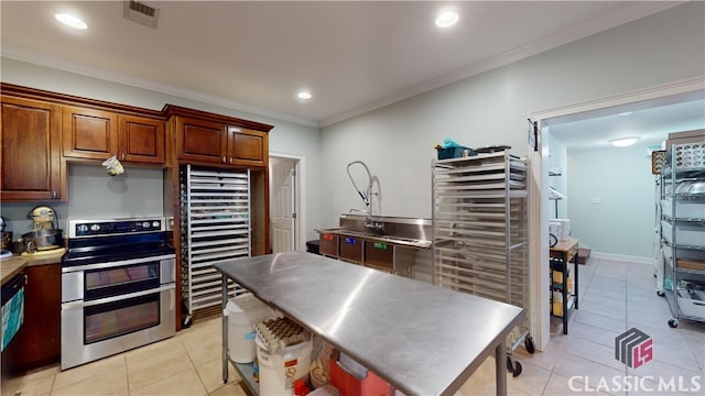 kitchen featuring crown molding, light tile patterned floors, and stainless steel electric range oven