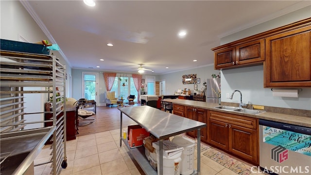 kitchen with stainless steel appliances, ornamental molding, sink, light tile patterned flooring, and ceiling fan