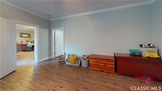 misc room with crown molding and hardwood / wood-style flooring