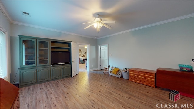 interior space with light hardwood / wood-style floors, crown molding, and ceiling fan