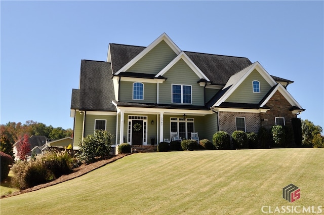 craftsman-style home with covered porch and a front yard