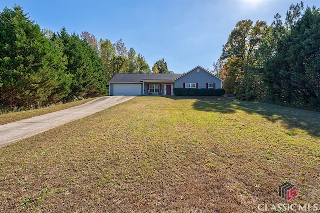 view of front of property with a front yard and a garage