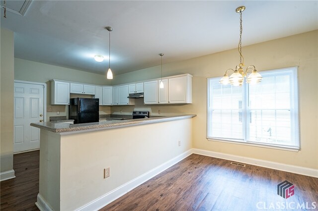 kitchen featuring black fridge, white cabinetry, decorative light fixtures, dark hardwood / wood-style flooring, and kitchen peninsula