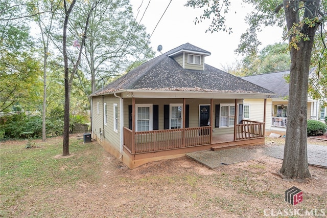 bungalow-style house featuring a porch and central AC