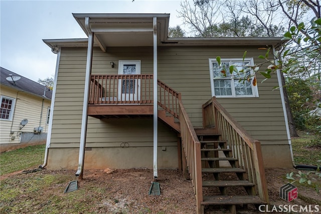 back of property featuring a wooden deck