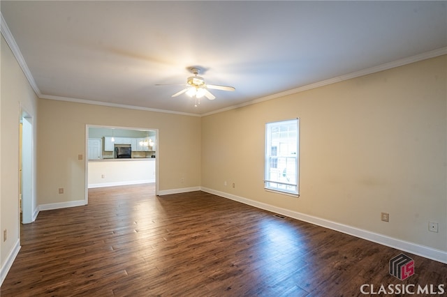 empty room with ornamental molding, dark hardwood / wood-style floors, and ceiling fan