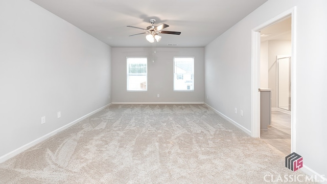 spare room with light carpet and ceiling fan