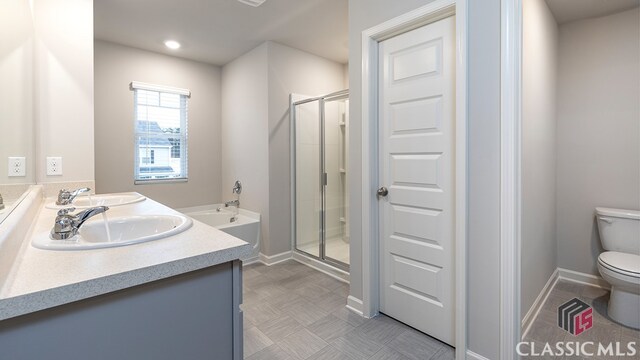 full bathroom featuring vanity, independent shower and bath, and toilet