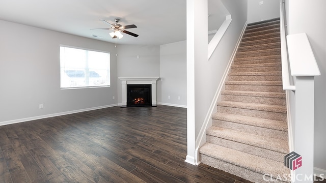 stairway with ceiling fan and hardwood / wood-style floors