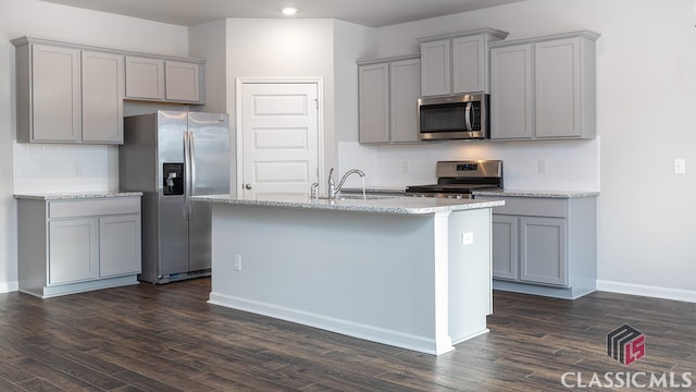 kitchen featuring appliances with stainless steel finishes, dark wood-type flooring, and gray cabinets