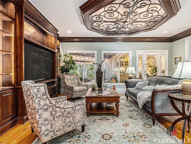 sitting room featuring light hardwood / wood-style flooring and ornamental molding