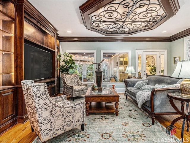 living room with ornamental molding, light wood-type flooring, and recessed lighting