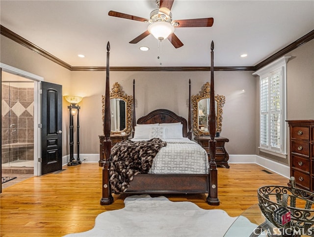 bedroom with hardwood / wood-style flooring, ensuite bath, ceiling fan, and crown molding