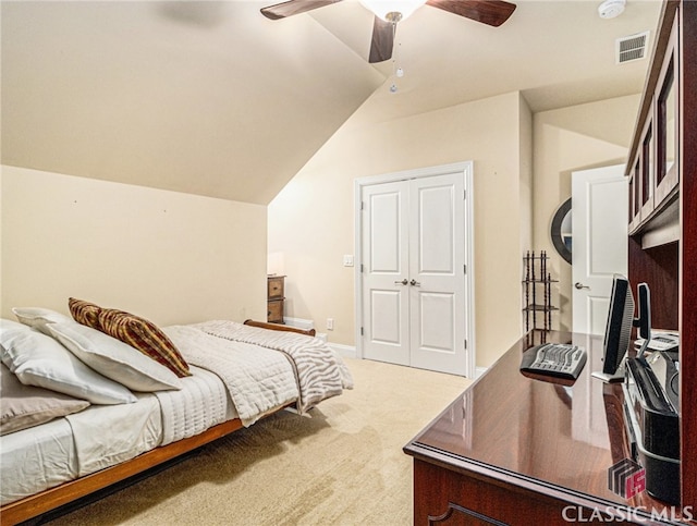 bedroom featuring carpet, a closet, vaulted ceiling, and ceiling fan