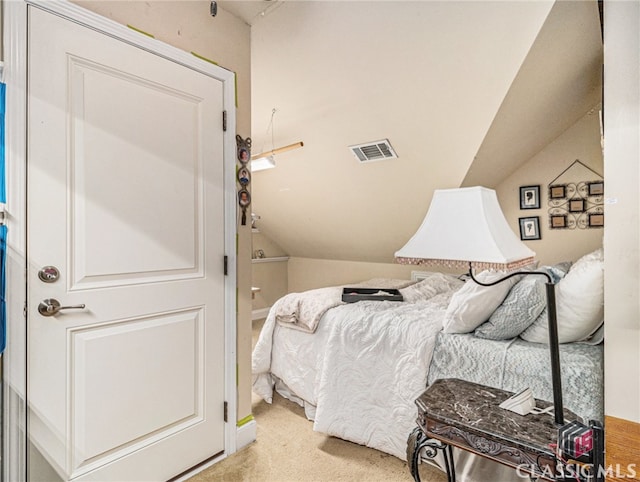 carpeted bedroom with vaulted ceiling