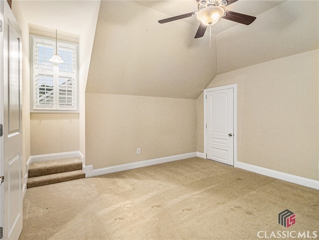 bonus room with lofted ceiling, ceiling fan, and carpet floors