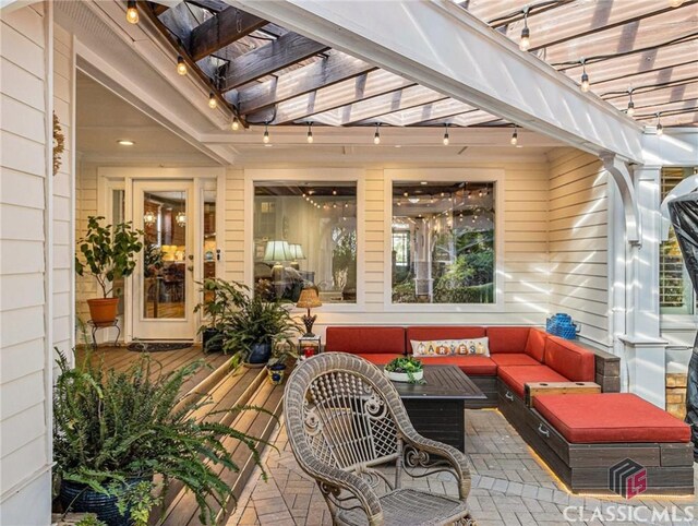 view of patio with a pergola, an outdoor hangout area, and a wooden deck