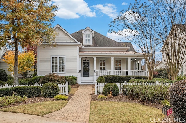 view of front of house featuring covered porch and a front lawn