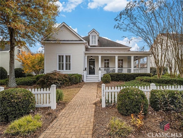 view of front of property with a porch and fence