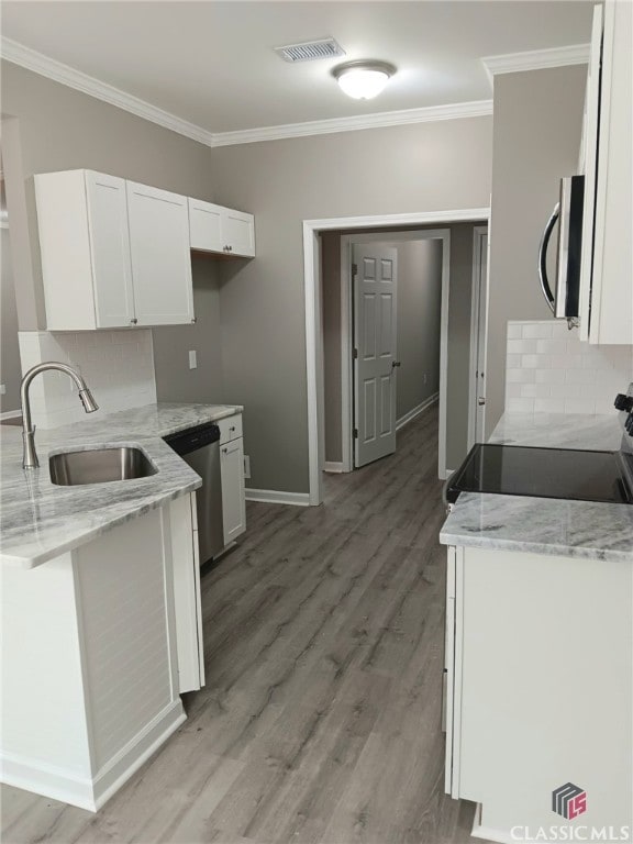 kitchen featuring light stone countertops, sink, white cabinetry, and stainless steel appliances