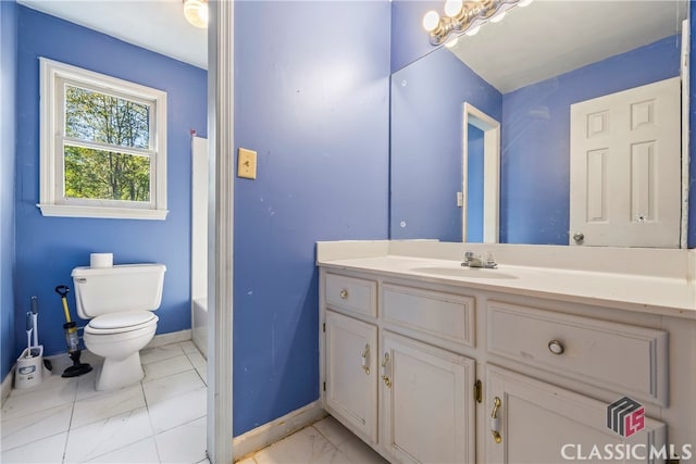 bathroom featuring toilet, vanity, and a bath