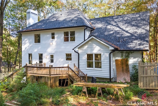 rear view of house featuring a wooden deck