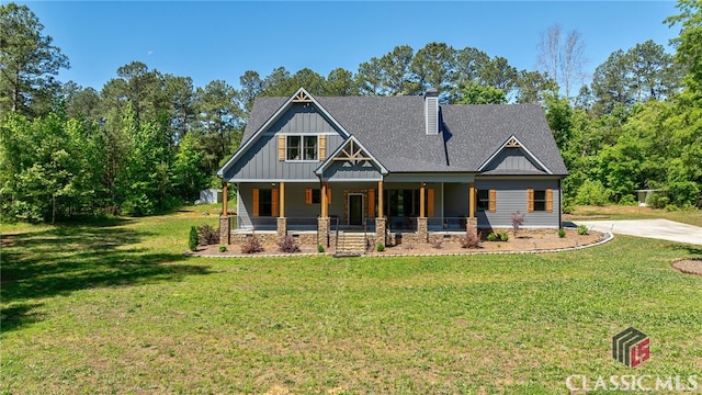 craftsman-style house featuring covered porch and a front lawn