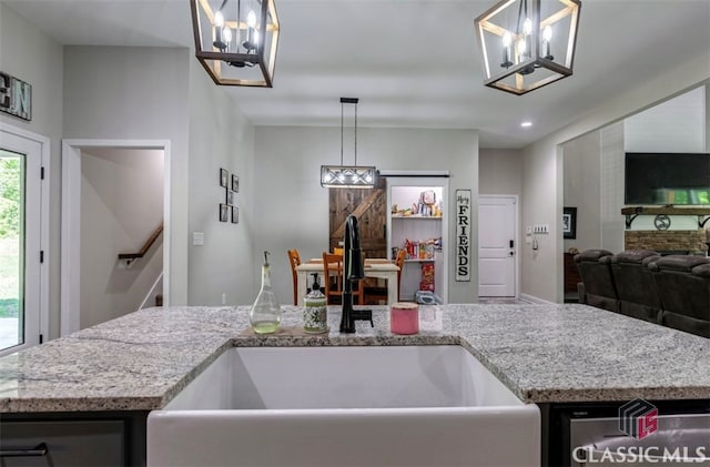 kitchen featuring sink, a wealth of natural light, and decorative light fixtures