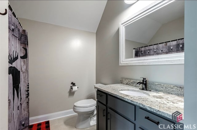 bathroom featuring vanity, toilet, tile patterned flooring, and vaulted ceiling