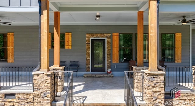 entrance to property with ceiling fan and a porch